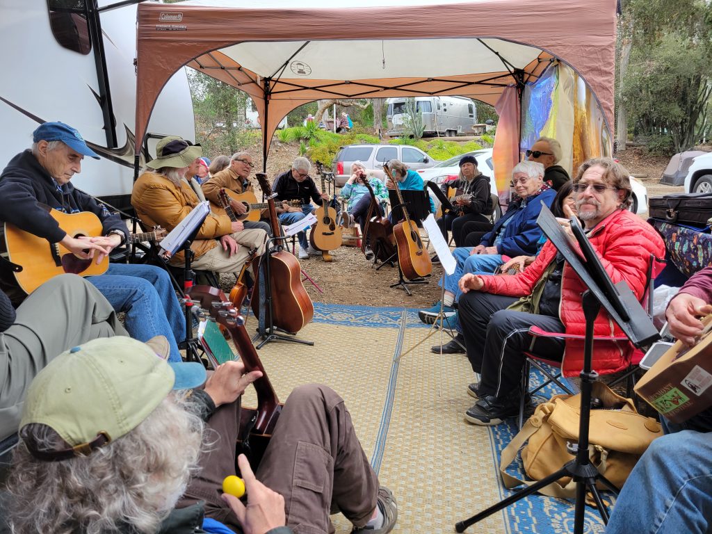 Photograph of Kenney Grove campers playing in a song circle.